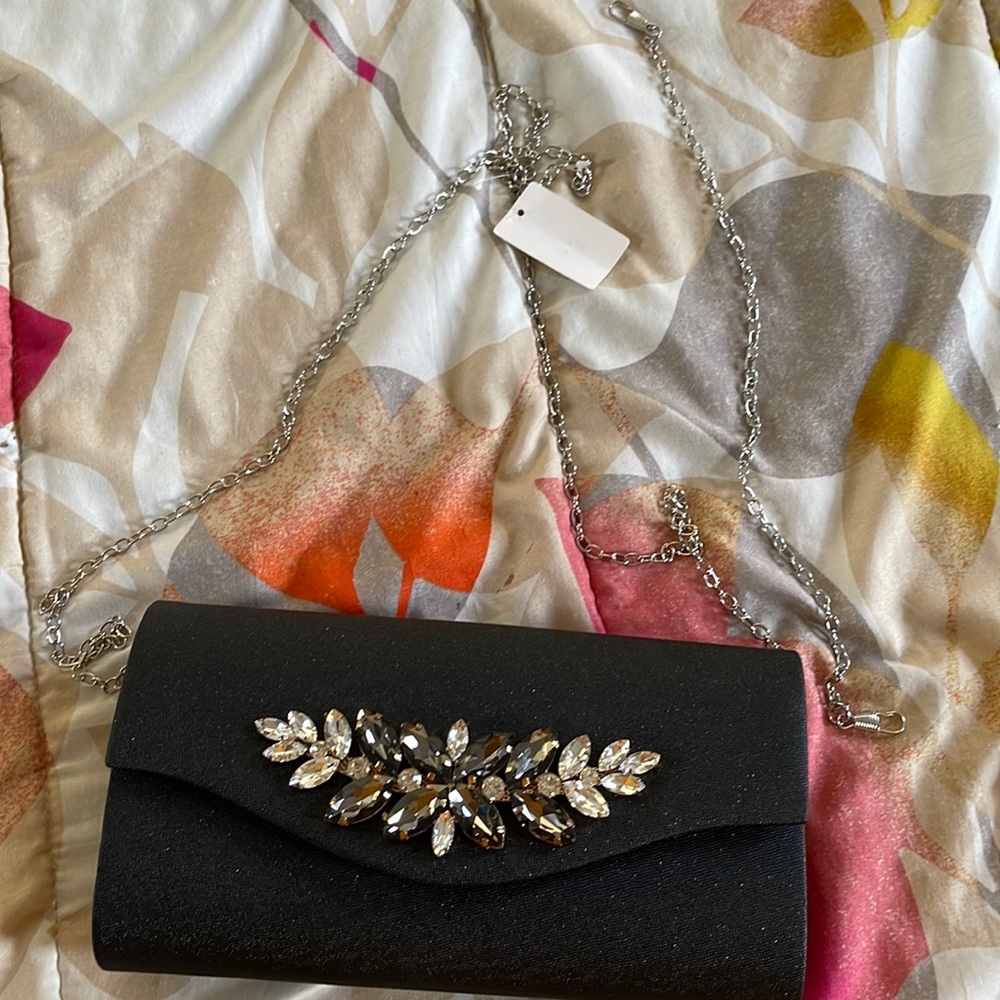 Black clutch with short, long and no chain options. Perfect formal wear